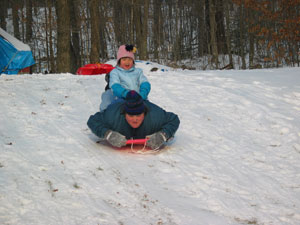 Emily Meng Lan, (5 years old in photo) is riding on top of Mommy, Paula, in this photo from December 2004.