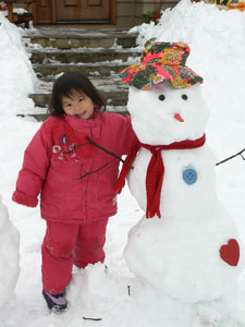 Kayla Xiu Yuan, 4 1/2 years old, of Ontario, Canada, poses by the snowman she made for her awaited sisted Anya, still in China. Kayla Xiu Yuan, 4 1/2 years old, of Ontario, Canada, poses by the snowman she made for her awaited sisted Anya, still in China.