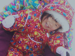 Lizzie, age 2, braves the deep snow and the cold Montana winter, on a search for a Christmas tree in 2008.