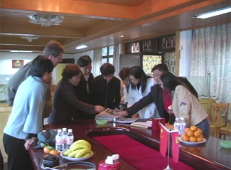 Orphanage staff looking through the 2004 Chenzhou Families portfolio.